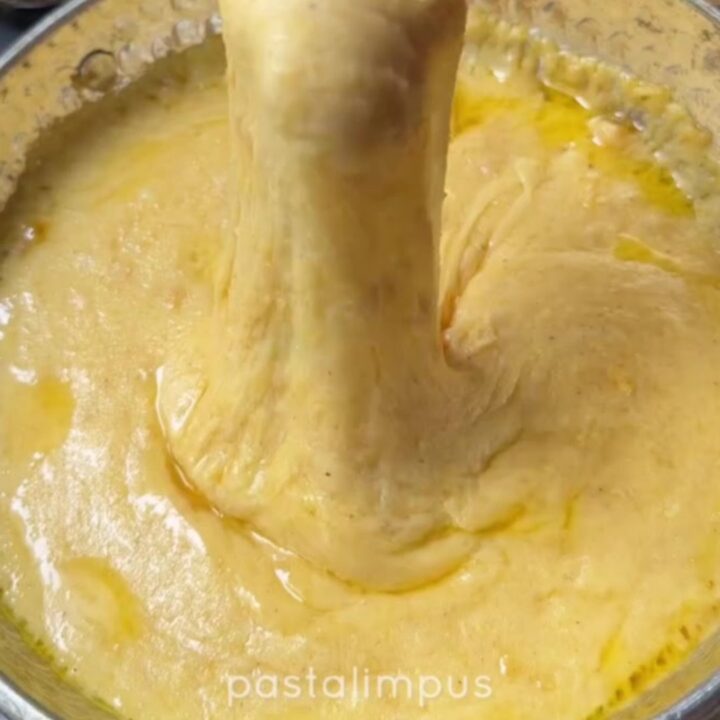Black Sea kuymak in a copper pan with cheese pulling high on a fork
