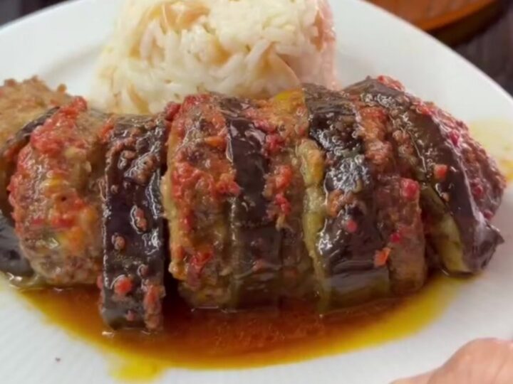 Bubbling baked eggplant kebab with meatballs in tomato glaze in a baking dish