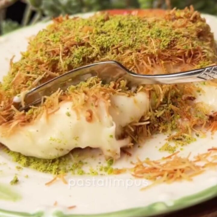 A square slice of kadayıf custard dessert on a plate, showing crispy golden top and creamy custard layer.