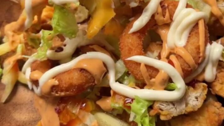 Cross-section of a crispy chicken fry dürüm wrap with melted cheese and fries