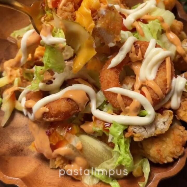 Cross-section of a crispy chicken fry dürüm wrap with melted cheese and fries