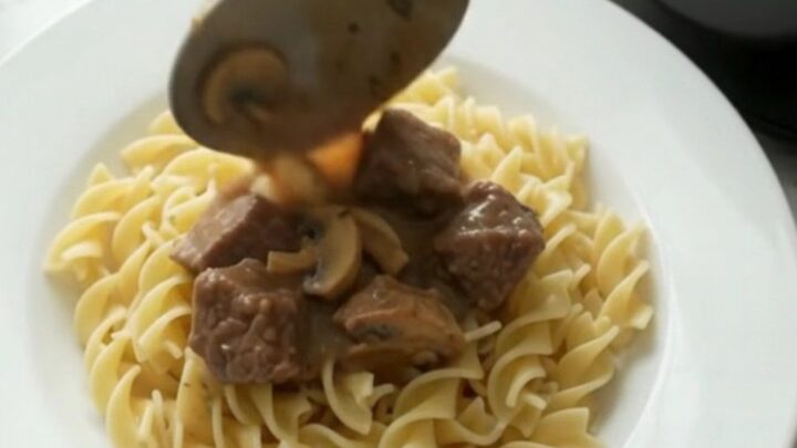 Creamy beef stroganoff in a slow cooker, with tender beef and mushrooms in a rich sauce