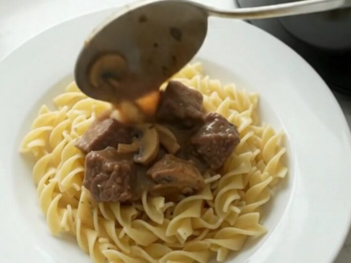 Creamy beef stroganoff in a slow cooker, with tender beef and mushrooms in a rich sauce