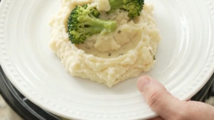 Creamy Swiss broccoli chicken in a slow cooker, with melted cheese and tender chicken pieces.