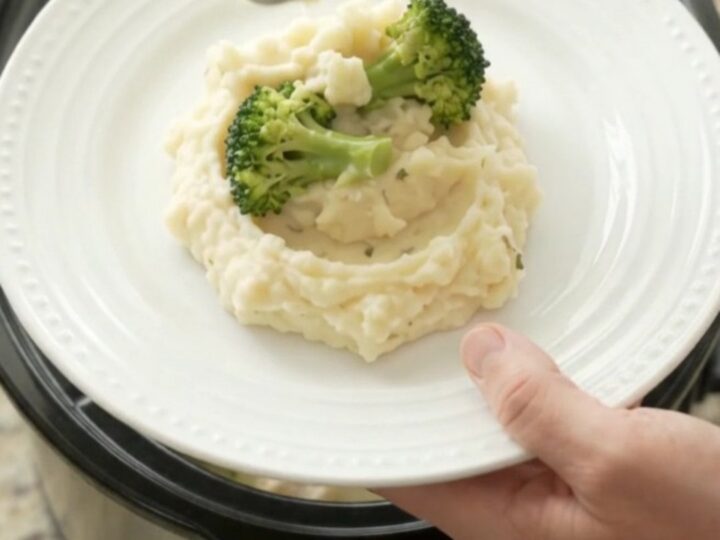 Creamy Swiss broccoli chicken in a slow cooker, with melted cheese and tender chicken pieces.