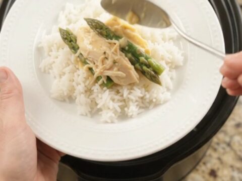 Creamy cheddar asparagus chicken in a slow cooker, with shredded chicken and asparagus in a rich golden sauce.