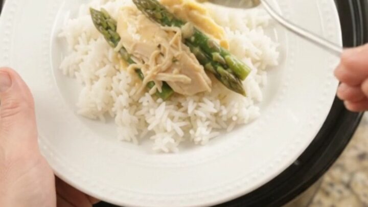 Creamy cheddar asparagus chicken in a slow cooker, with shredded chicken and asparagus in a rich golden sauce.