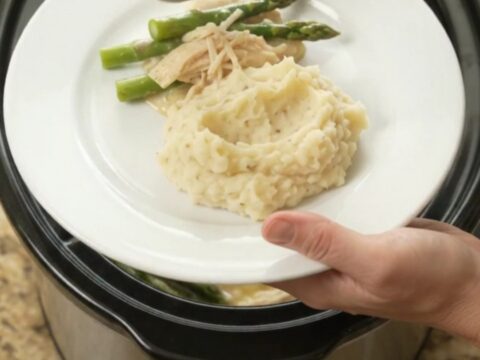 Creamy Swiss asparagus chicken in a slow cooker, with melted cheese and tender chicken.