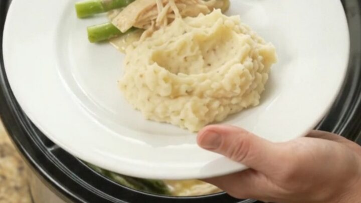 Creamy Swiss asparagus chicken in a slow cooker, with melted cheese and tender chicken.