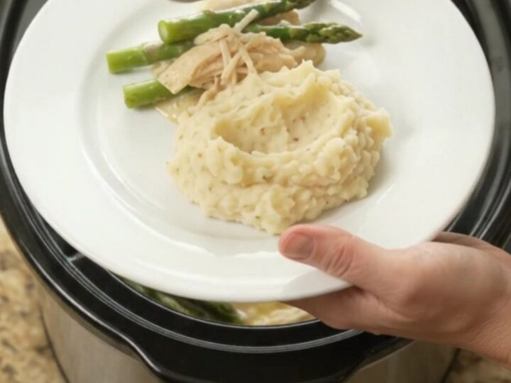 Creamy Swiss asparagus chicken in a slow cooker, with melted cheese and tender chicken.