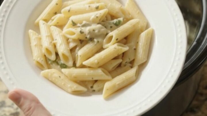 Creamy mozzarella green bean chicken in a slow cooker, with melted cheese and tender green beans
