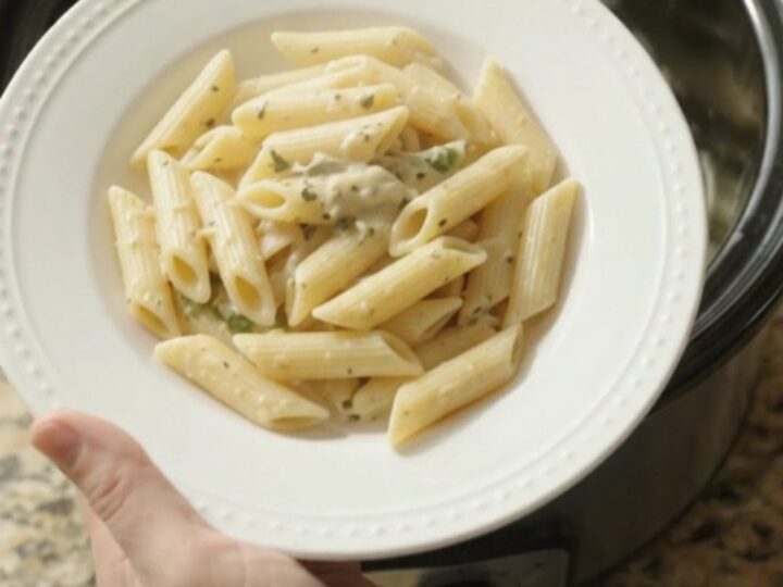 Creamy mozzarella green bean chicken in a slow cooker, with melted cheese and tender green beans