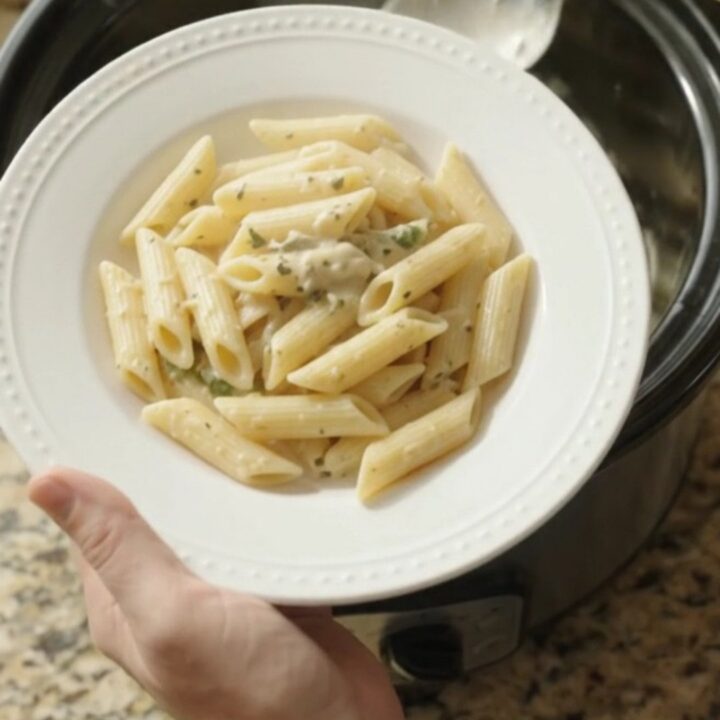 Creamy mozzarella green bean chicken in a slow cooker, with melted cheese and tender green beans