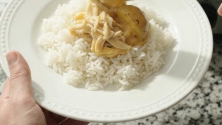 Slow cooker creamy cheddar chicken and baby potatoes in a rich sauce, topped with melted cheddar and butter.
