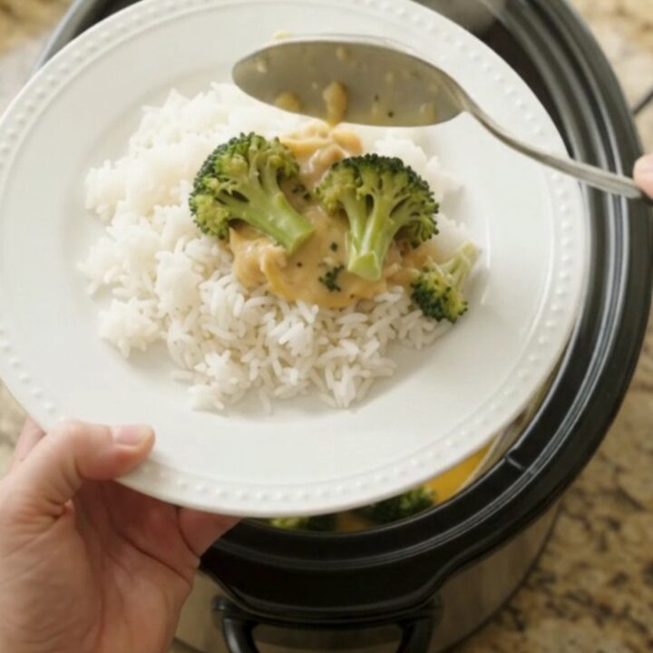 Slow cooker filled with creamy cheddar broccoli chicken thighs