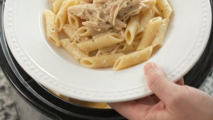 Creamy mozzarella French onion chicken in a slow cooker, with tender shredded chicken and melted cheese