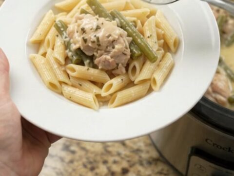Slow cooker creamy mozzarella green bean chicken thighs in a bubbling sauce