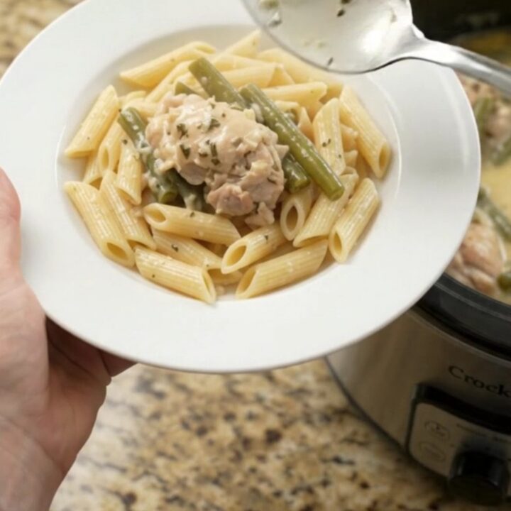 Slow cooker creamy mozzarella green bean chicken thighs in a bubbling sauce