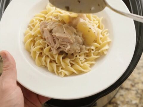 Velvety Parmesan baby potato chicken thighs in a slow cooker, creamy sauce bubbling
