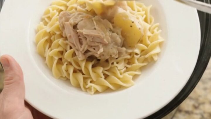 Velvety Parmesan baby potato chicken thighs in a slow cooker, creamy sauce bubbling