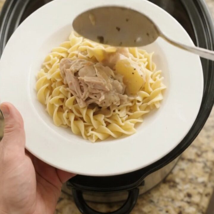 Velvety Parmesan baby potato chicken thighs in a slow cooker, creamy sauce bubbling