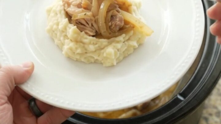 Velvety Swiss French Onion Chicken Thighs in a slow cooker, creamy sauce with caramelized onions