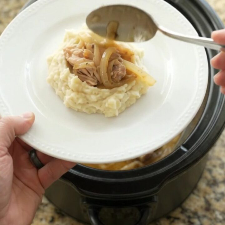 Velvety Swiss French Onion Chicken Thighs in a slow cooker, creamy sauce with caramelized onions