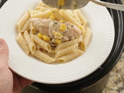 Golden mozzarella sweet corn chicken tenders in a slow cooker, creamy sauce with shredded chicken and corn