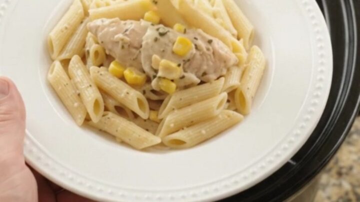Golden mozzarella sweet corn chicken tenders in a slow cooker, creamy sauce with shredded chicken and corn