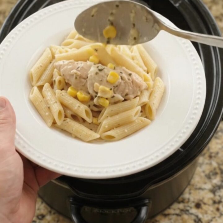Golden mozzarella sweet corn chicken tenders in a slow cooker, creamy sauce with shredded chicken and corn