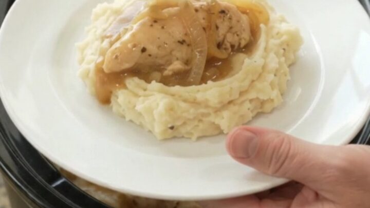 Golden Swiss French Onion Chicken Tenders in a slow cooker, creamy sauce with melted cheese and onions