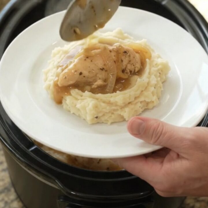 Golden Swiss French Onion Chicken Tenders in a slow cooker, creamy sauce with melted cheese and onions