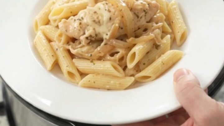 Golden mozzarella French onion chicken tenders bubbling in a slow cooker