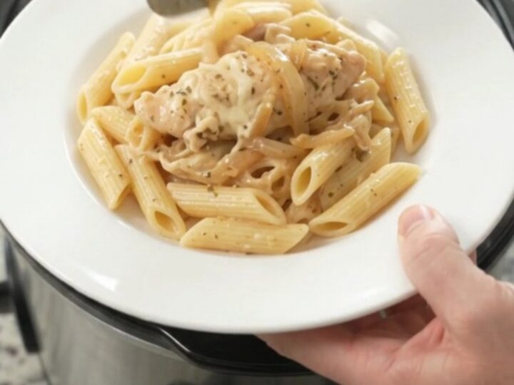 Golden mozzarella French onion chicken tenders bubbling in a slow cooker