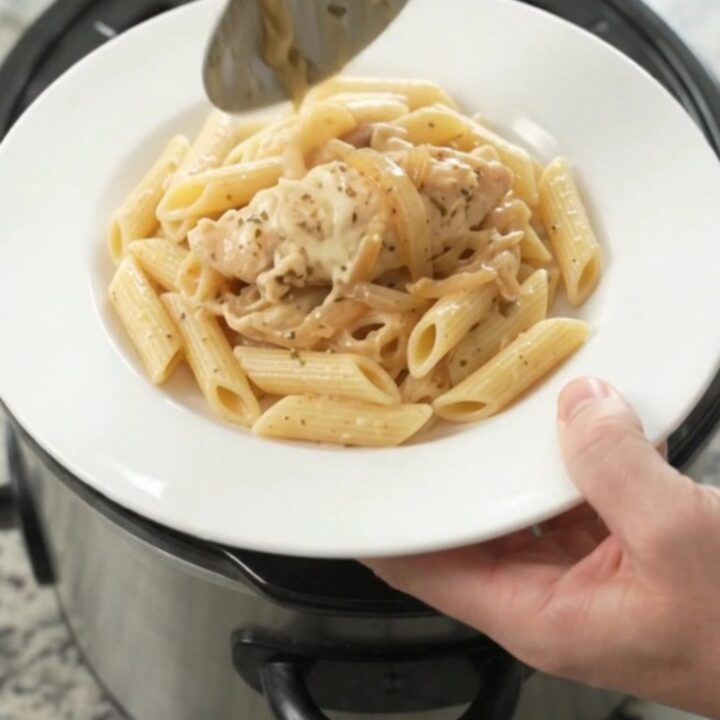 Golden mozzarella French onion chicken tenders bubbling in a slow cooker