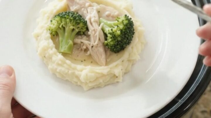 Slow cooker filled with creamy Swiss broccoli turkey breast, bubbling and steaming