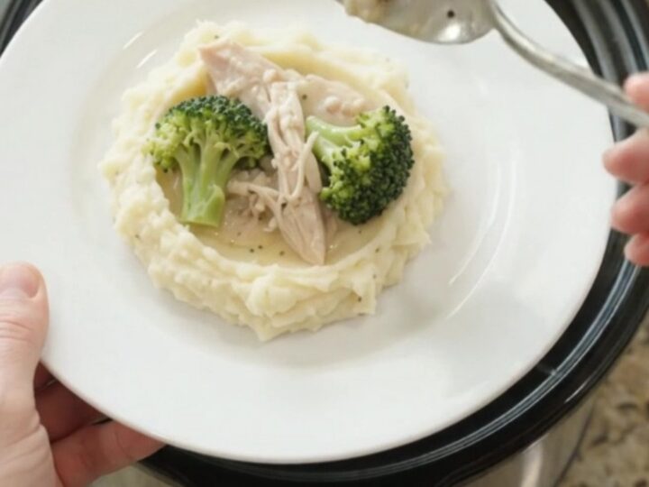 Slow cooker filled with creamy Swiss broccoli turkey breast, bubbling and steaming