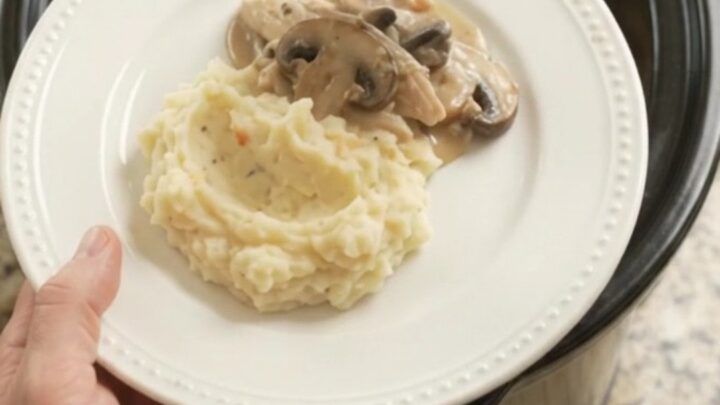 Creamy Swiss mushroom turkey breast in a slow cooker, with melted cheese and sauce