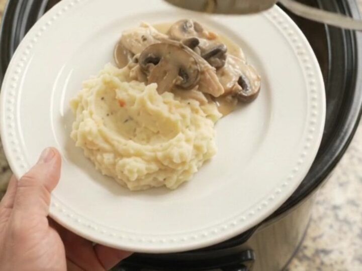 Creamy Swiss mushroom turkey breast in a slow cooker, with melted cheese and sauce
