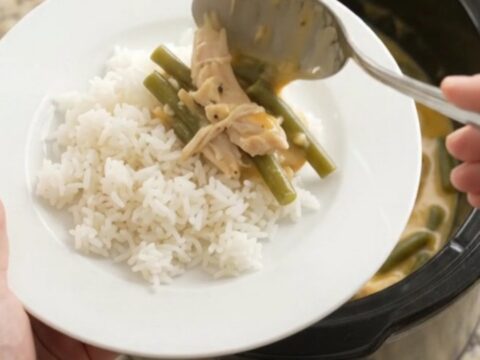 Creamy crockpot turkey and green beans with melted cheddar cheese sauce in a slow cooker