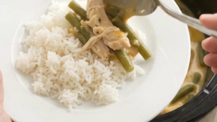 Creamy crockpot turkey and green beans with melted cheddar cheese sauce in a slow cooker