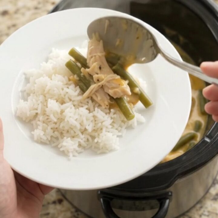 Creamy crockpot turkey and green beans with melted cheddar cheese sauce in a slow cooker