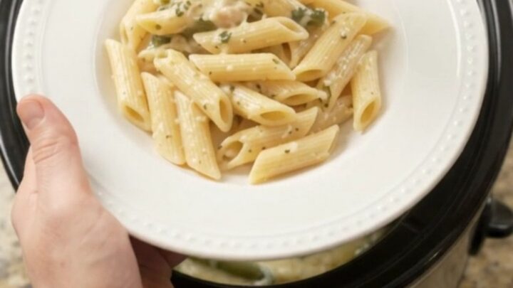 Slow cooker full of creamy mozzarella turkey and green beans, with steam rising