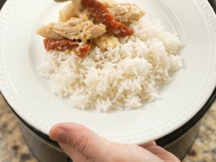 Shredded turkey breast in creamy cheddar sauce with sun-dried tomatoes in a slow cooker