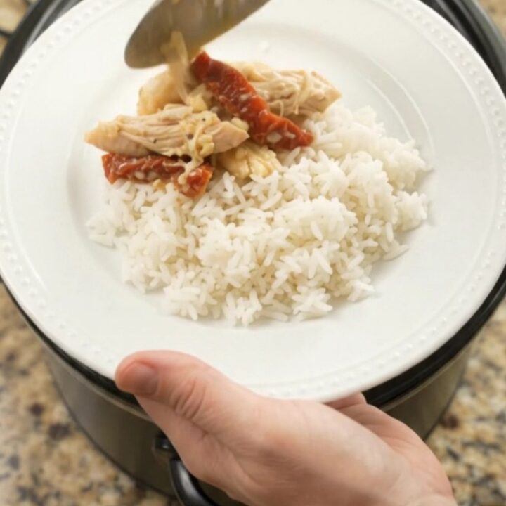Shredded turkey breast in creamy cheddar sauce with sun-dried tomatoes in a slow cooker