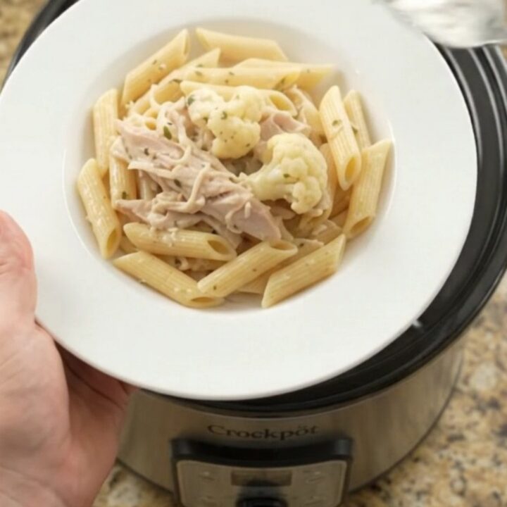 Slow cooker turkey breast with cauliflower and melted mozzarella in a creamy sauce