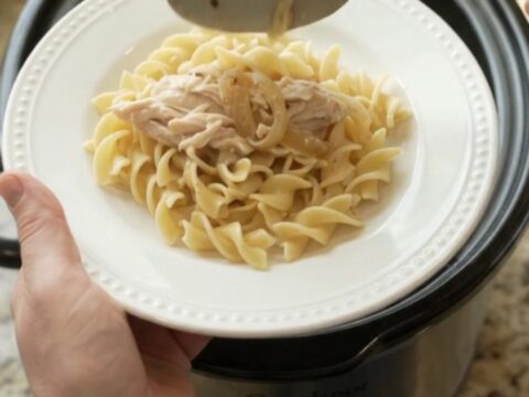 Slow cooker turkey breast with creamy French onion sauce, topped with melted cheese and onions.