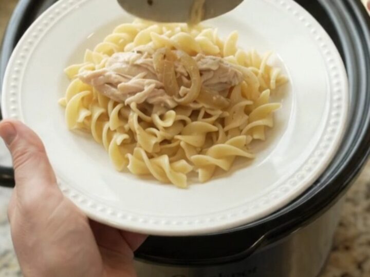 Slow cooker turkey breast with creamy French onion sauce, topped with melted cheese and onions.