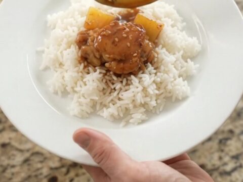 Caramelized chicken thighs and pineapple in a slow cooker with teriyaki glaze