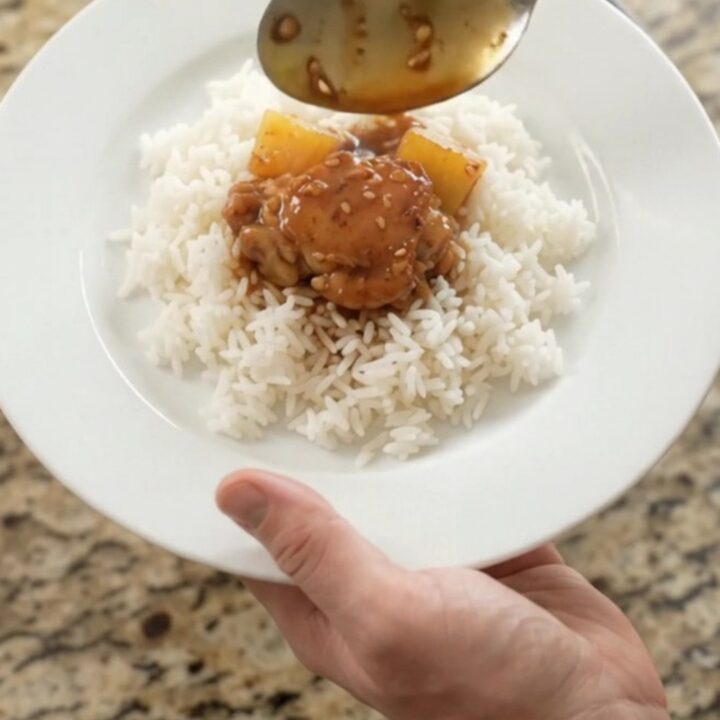Caramelized chicken thighs and pineapple in a slow cooker with teriyaki glaze